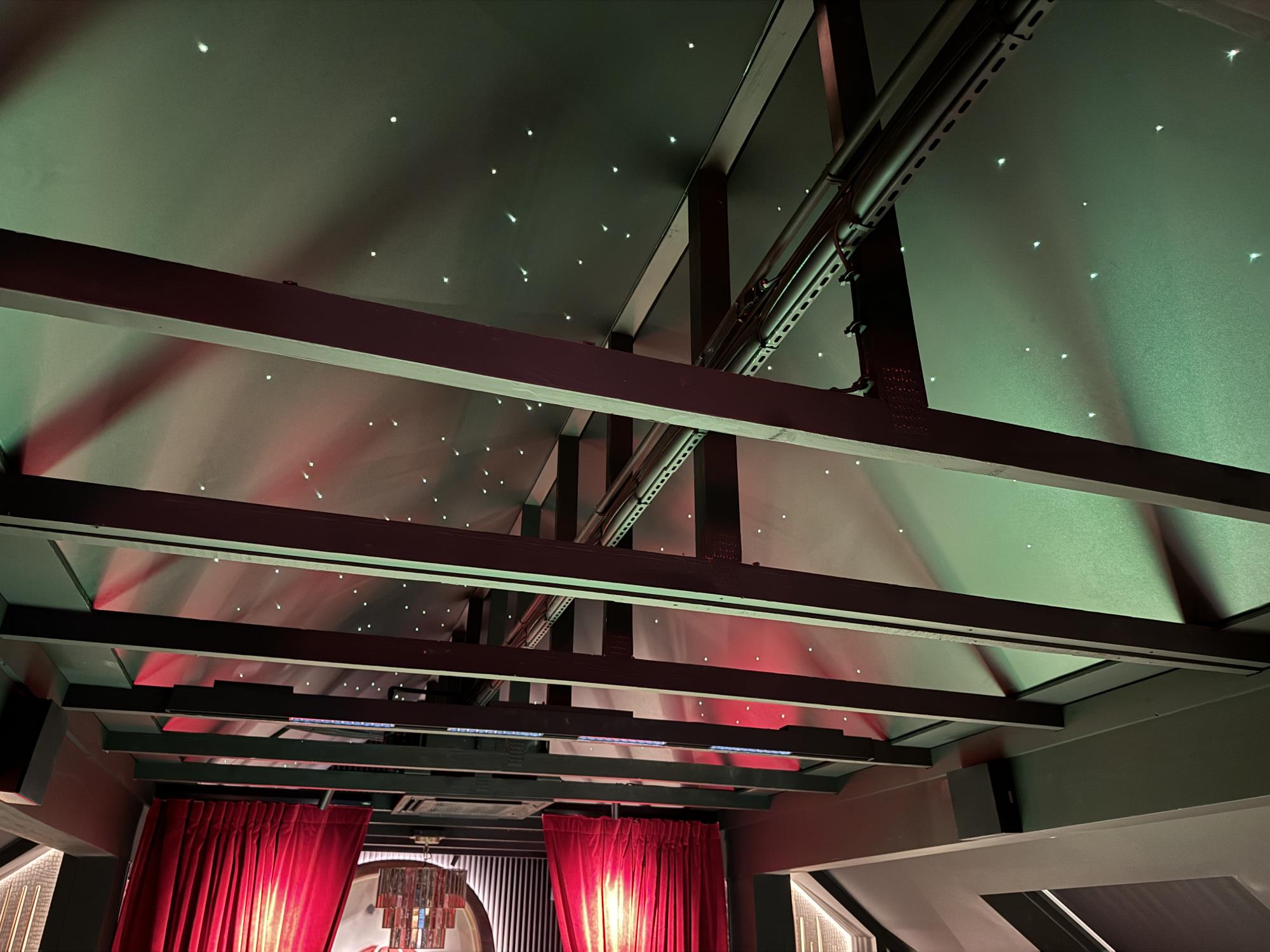 Black Stretch Starlight Ceiling between rafters in bar