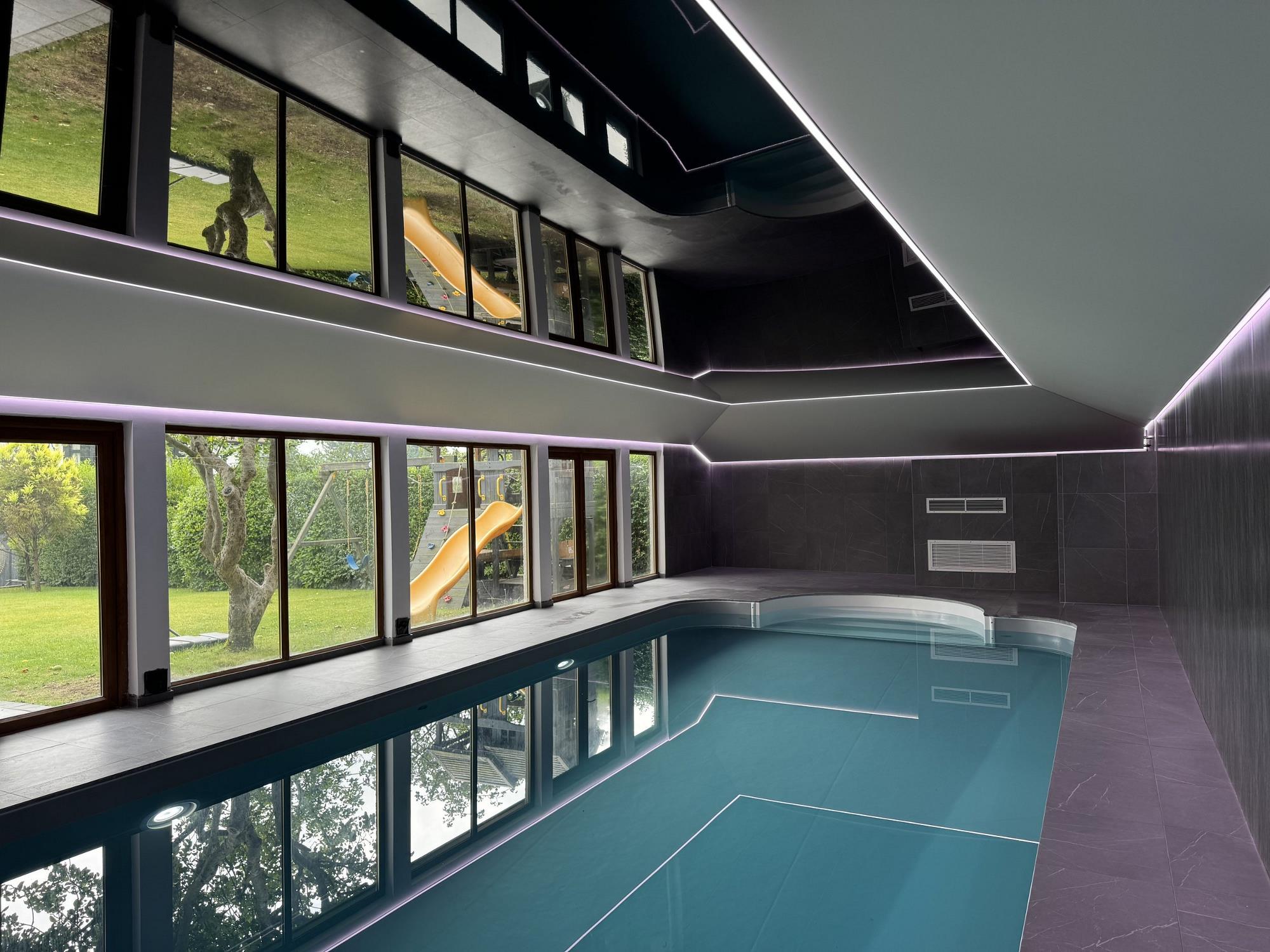 Pool area with illuminated stretched ceiling